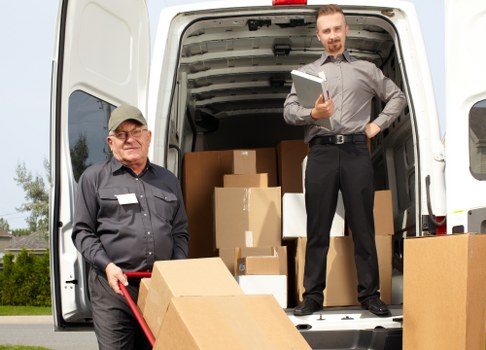 Staff member checking secure load placement in vehicle