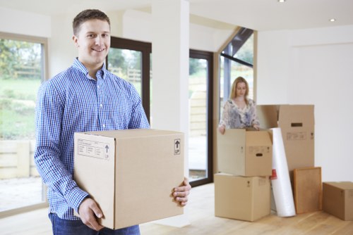 Packed boxes and furniture being loaded into a moving van