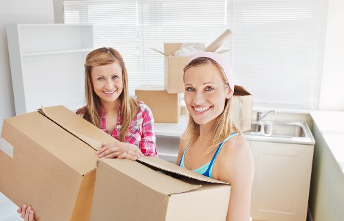 Packed boxes and furniture ready for collection by removals crew