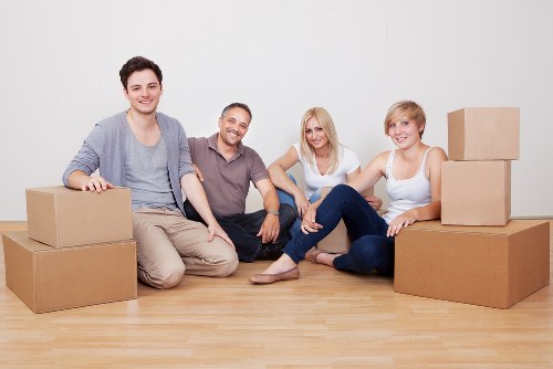 Family preparing boxes for house removals in Norbury