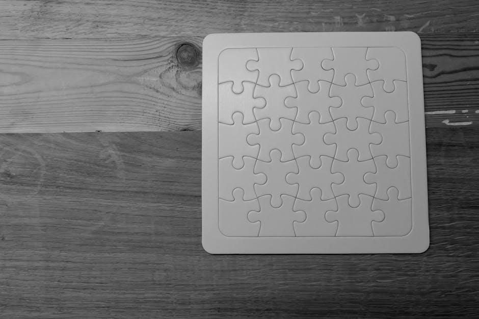 A white plastic floor mat with a raised puzzle-piece pattern located on a wooden floor, positioned near a doorway. The wooden flooring comprises two different types of planks, one lighter and visibly textured, and the other darker with a smoother surface. The image shows part of a door threshold at the top left corner, indicating the mat is placed just inside or outside a property entrance, possibly in a staircase or hallway area during a home relocation or furniture transport process, illustrating a step in the logistical challenges of house removals managed by Man with Van Norbury.